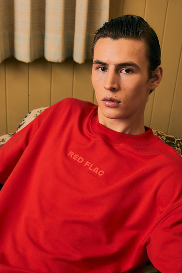 Bonkers Corner Certified Red Flag oversized T-shirt in red with bold graphic print, relaxed fit, and casual streetwear style.