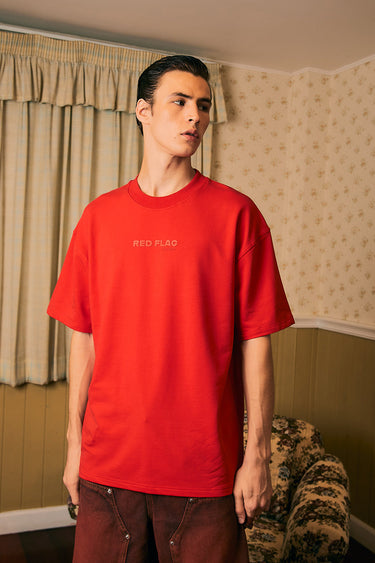 Bonkers Corner red oversized T-shirt with "Red Flag" graphic, relaxed fit, cotton material, casual streetwear style.