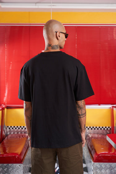 Bonkers Corner Chuckie embroidery oversized T-shirt featuring a colorful cartoon character design on soft fabric.