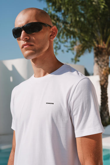 Bonkers Corner classic white 100% Supima cotton relaxed fit T-shirt laid flat, showcasing soft fabric and comfortable style.