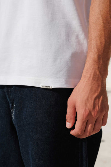 Bonkers Corner white 100% Supima cotton relaxed fit T-shirt, casual and comfortable, shown on a model.