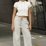 Bonkers Corner cloud grey wide-leg sweatpants displayed on a hanger, showcasing their relaxed fit and soft fabric.