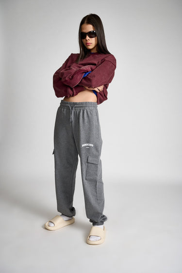 Dark grey melange cargo pants by Bonkers Corner, featuring multiple pockets and a relaxed fit, shown on a model.