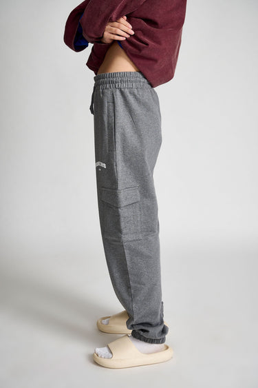 Dark grey melange cargo pants by Bonkers Corner, with multiple pockets and a relaxed fit, shown on a model.