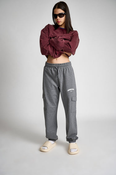Dark grey melange cargo pants from Bonkers Corner with multiple pockets and relaxed fit, shown on a model.