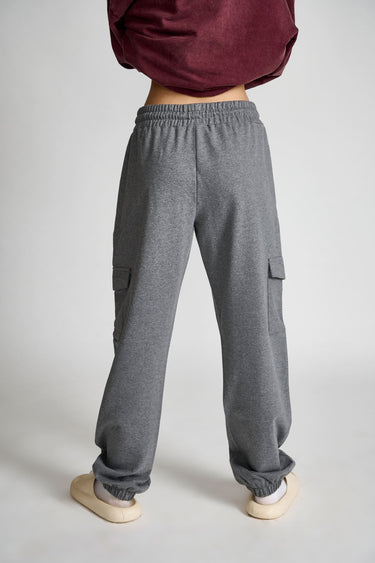 Dark grey melange cargo pants by Bonkers Corner, showing relaxed fit with multiple pockets and adjustable waistband.