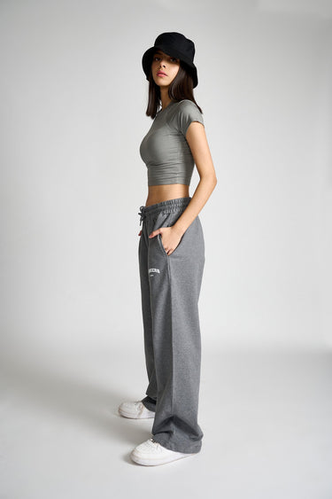 Dark grey melange wide-leg pants by Bonkers Corner, shown hanging on a clothing rack with a focus on the fabric and fit.