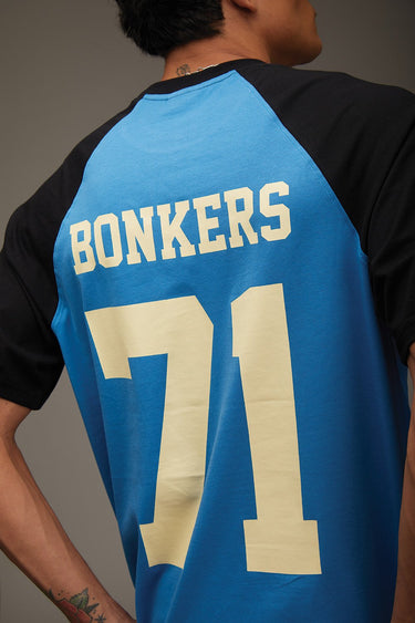Bonkers Corner Dropout University oversized T-shirt in white with university logo and casual fit, displayed on a hanger.