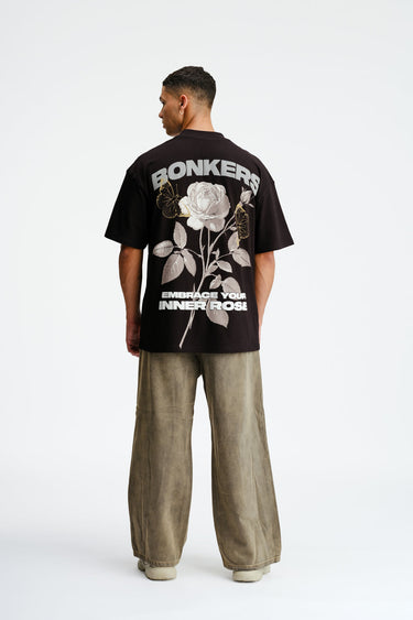 Light pink oversized T-shirt by Bonkers Corner featuring a floral rose design and relaxed fit, perfect for casual wear.