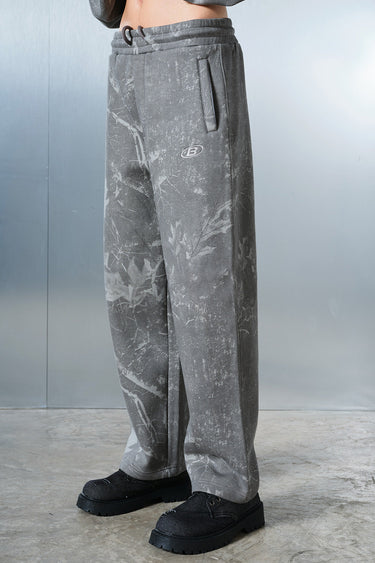 Faded grey Bonkers Corner joggers shown on a model, featuring a relaxed fit and elastic waistband for comfortable casual wear.