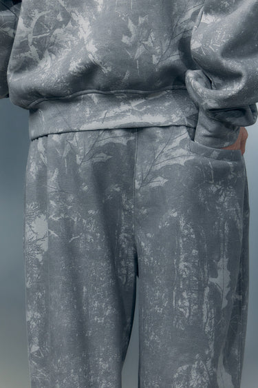 Faded grey Bonkers Corner joggers with elastic waistband and tapered fit, shown on a model.