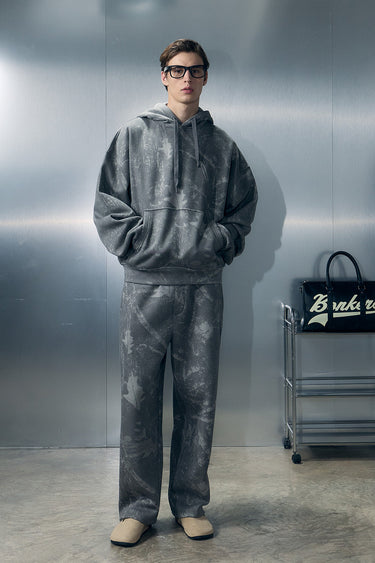 Bonkers Corner faded grey joggers shown on a model, featuring a relaxed fit and comfortable elastic waistband.