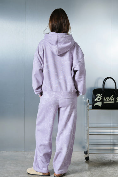 Faded lavender hoodie by Bonkers Corner, featuring a relaxed fit and soft fabric, shown on a hanger.