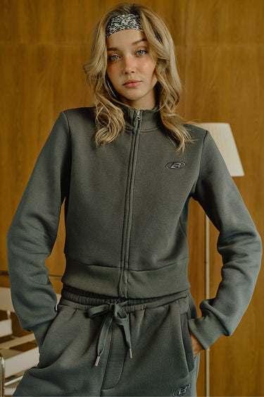 Bonkers Corner Fadeout Olive Crop Zipper Jacket shown on a model, featuring a stylish zipper front and cropped fit.