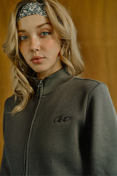 Bonkers Corner Fadeout Olive Crop Zipper Jacket shown on a model, featuring a stylish olive green color and modern zippered design.