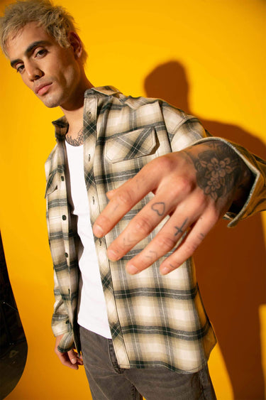 Green plaid flannel oversized shirt by Bonkers Corner, showing a relaxed fit with a classic checkered pattern and button front.