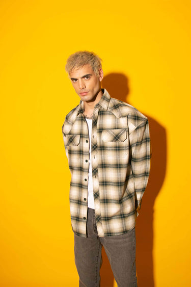 Green plaid flannel oversized shirt by Bonkers Corner, showing a relaxed fit with a classic plaid pattern and button front.