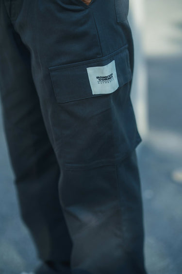 Grey cargo pants with utility pockets from Bonkers Corner, featuring a relaxed fit and functional design.