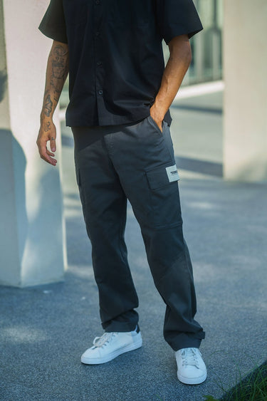 Grey cargo pants with utility pockets from Bonkers Corner, featuring a relaxed fit and multiple functional pockets.