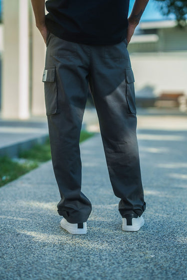 Grey cargo pants with utility pockets by Bonkers Corner, showcasing a relaxed fit and multiple functional pockets.