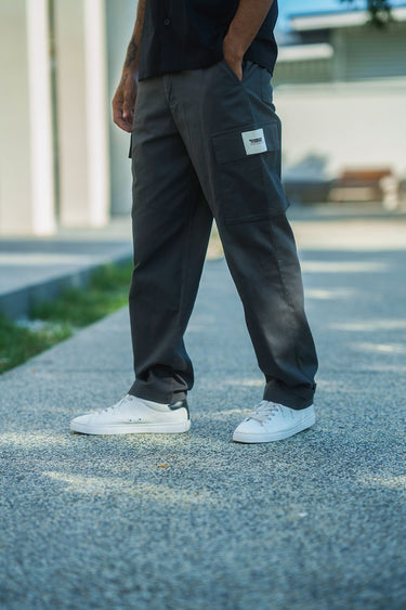 Grey cargo pants with utility pockets by Bonkers Corner, featuring a relaxed fit and functional design.