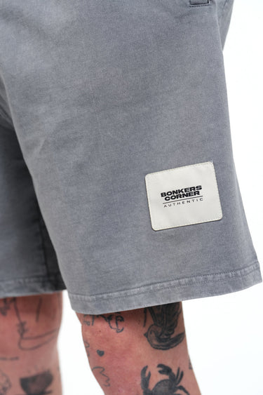 Grey heavyweight faded shorts by Bonkers Corner, showing a relaxed fit with distressed fabric and casual style.
