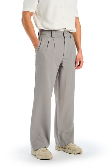 Grey loose fit tailored trousers by Bonkers Corner, shown on a model, highlighting the relaxed yet structured style and fabric texture.