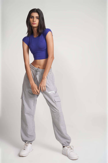 Grey melange cargo pants by Bonkers Corner, featuring multiple pockets and a relaxed fit, shown on a model.