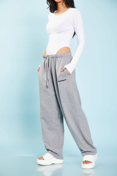Grey melange loose fit joggers from Bonkers Corner with a relaxed style and soft fabric, shown on a model.