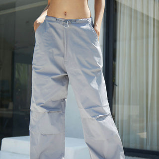 Grey parachute pants by Bonkers Corner featuring a relaxed fit and adjustable waistband, displayed on a neutral background.