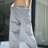 Grey parachute pants by Bonkers Corner featuring a relaxed fit and adjustable waistband, displayed on a neutral background.