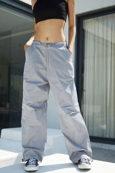 Grey parachute pants by Bonkers Corner featuring a relaxed fit and adjustable waistband, displayed on a neutral background.