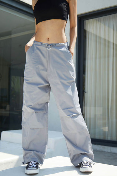 Grey parachute pants by Bonkers Corner featuring a relaxed fit and adjustable waistband, displayed on a neutral background.