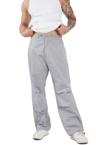 Grey parachute pants by Bonkers Corner featuring a relaxed fit and drawstring waist, shown on a model.
