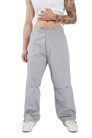 Grey parachute pants by Bonkers Corner featuring a relaxed fit and adjustable waistband, displayed on a model.