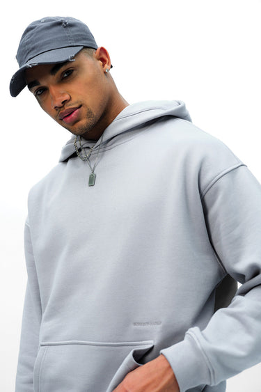 Grey Wear A Hug oversized hoodie by Bonkers Corner, featuring a relaxed fit and casual style, displayed on a hanger.