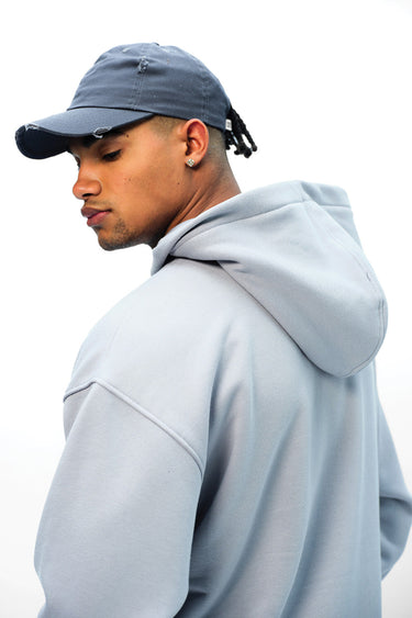Grey Wear A Hug oversized hoodie by Bonkers Corner, featuring a relaxed fit and soft fabric, displayed on a hanger.