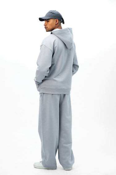 Grey Wear A Hug oversized hoodie by Bonkers Corner, showing a cozy, relaxed fit with a front pocket and drawstring hood.