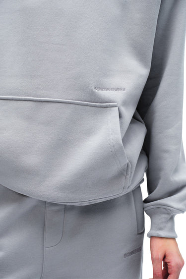 Grey Wear A Hug oversized hoodie by Bonkers Corner, featuring a relaxed fit and soft fabric, shown on a model.