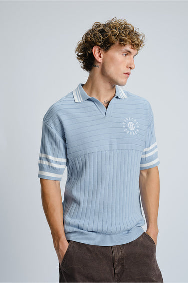 Blue Icy Spicy Knit Polo shirt by Bonkers Corner displayed on a hanger with close-up fabric texture.