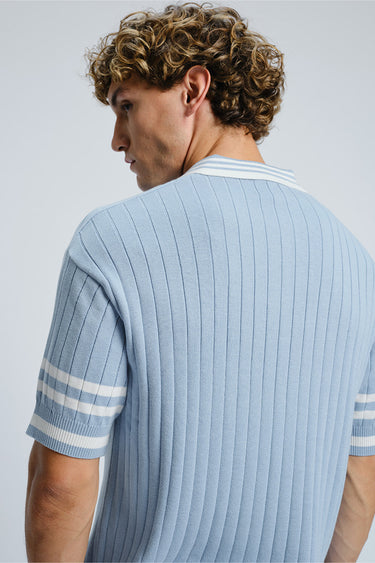 Bonkers Corner Icy Spicy Knit Polo shirt in light blue with a collar and short sleeves, displayed on a plain background.