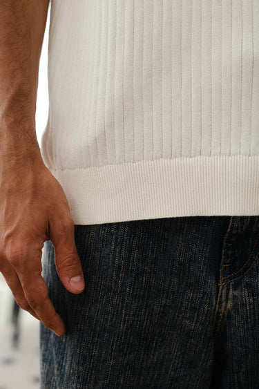 Ivory knit polo T-shirt by Bonkers Corner, featuring a classic collar, short sleeves, and textured knit fabric.