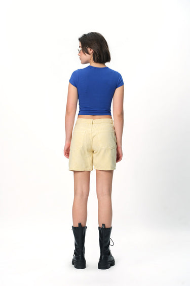 Bonkers Corner Leo Legacy Long Length Baby Tee featuring a relaxed fit and stylish design, shown in a light color.