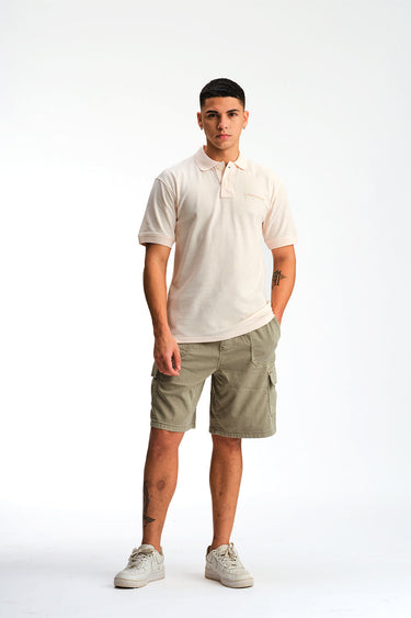 Light pink Bonkers Corner signature jacquard collar premium polo shirt displayed on a mannequin.