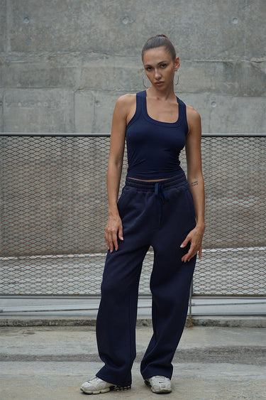 Navy blue Bonkers Corner On The Go joggers laid flat, showing elastic waistband and tapered fit for activewear comfort.
