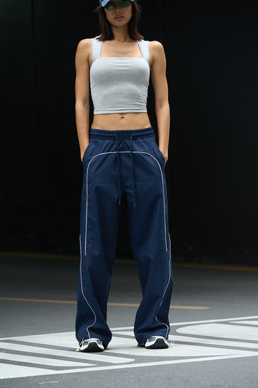 Navy blue sporty deconstructed loose pants by Bonkers Corner, featuring relaxed fit and casual style, shown laid flat.