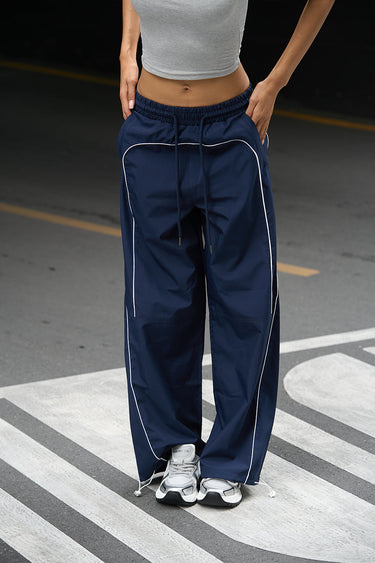 Navy blue sporty deconstructed loose pants by Bonkers Corner, featuring relaxed fit and casual style, shown on a model.