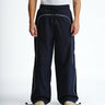 Navy blue sporty deconstructed loose pants from Bonkers Corner featuring relaxed fit and casual style.