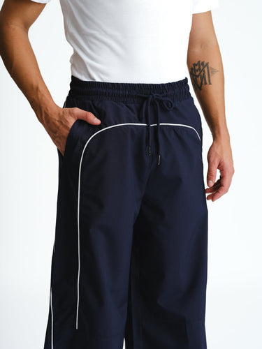 Navy blue sporty deconstructed loose pants by Bonkers Corner, featuring relaxed fit and casual style, shown on model.