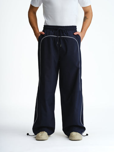 Navy blue sporty deconstructed loose pants by Bonkers Corner, featuring relaxed fit and casual style, shown on a model.